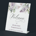 21st Birthday Purple Lilac Spring Flower Welcome Pedestal Sign<br><div class="desc">Soft watercolor purple lilacs create a pretty springtime 21st birthday welcome pedestal sign. This tabletop sign stands up on its own. Just one less thing to think about, right? The calligraphy adds an elegant touch. This item is part of the Purple Spring Lilac Flower collection. It lets you choose a...</div>
