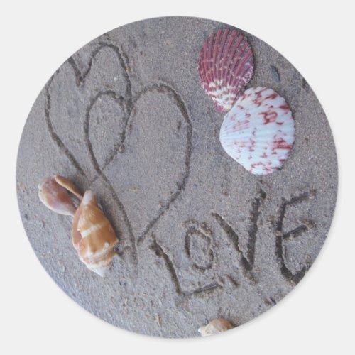 2 Hearts  in the sand with shells with Love Classic Round Sticker
