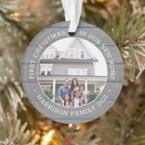 2 Photo 1st Christmas Housewarming Faux Gray Wood Ornament - Celebrate the joy of your new place with a custom two photo "First Christmas in our New Home" round faux wood acrylic ornament. All text and pictures on this template are simple to personalize and can be different or the same on front and back. (IMAGE & TEXT DESIGN TIPS: 1) To adjust position of wording, add spaces at beginning or end. 2) To center the photo exactly how you want, crop it into a square shape before uploading to the Zazzle website.) Modern farmhouse style design features a rustic grey faux wood background, stylish typography name and year, and 2 images of your choice. This unique family keepsake adds an elegant touch to Xmas home decorations or makes a thoughtful housewarming realtor gift idea. There's no place like a new home for the holidays!