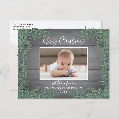 2 Photo Any Text Modern Farmhouse Greenery & Wood Holiday Postcard - Send stylish joyful greetings and share two of your favorite photos with this modern farmhouse style holiday postcard. All text on this template is simple to customize to include any wording, such as Merry Christmas, Happy Holidays, Seasons Greetings, New Year Cheers etc. (IMAGE PLACEMENT TIP:  An easy way to center a photo exactly how you want is to crop it before uploading to the Zazzle website.) Design features a rustic grey wood look background, festive watercolor pine greenery, handwritten style sketched script typography, and 2 pictures of your choice. Family and friends will love displaying this elegant personalized card.