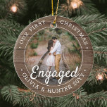2 Photo First Christmas Engaged Rustic Faux Wood Ceramic Ornament<br><div class="desc">Celebrate the joyful 1st holiday of your engagement with a custom 2 photo "Our First Christmas Engaged" round faux wood ceramic ornament. All wording and images on this template are simple to personalize and can be different or the same on front and back. (IMAGE & TEXT DESIGN TIPS: 1) To...</div>