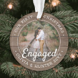 2 Photo First Christmas Engaged Rustic Faux Wood Ornament<br><div class="desc">Celebrate the joyful 1st holiday of your engagement with a custom 2 photo "Our First Christmas Engaged" round faux wood acrylic ornament. All wording and images on this template are simple to personalize and can be different or the same on front and back. (IMAGE & TEXT DESIGN TIPS: 1) To...</div>