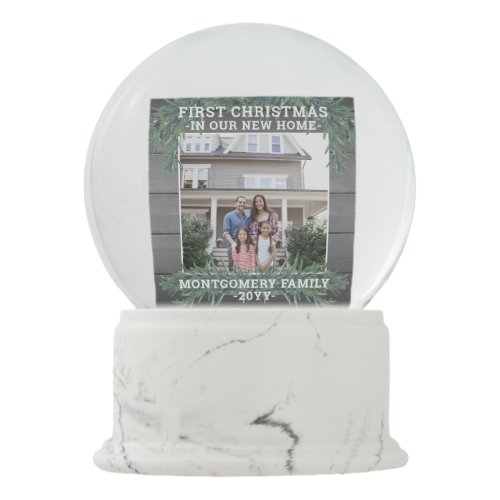 2 Photo First Christmas New Home Family Keepsake Snow Globe - Always have snow at your house for the holidays with this two photo "First Christmas in our New Home" snow globe. All text and pictures on this template are simple to customize and can be different or the same on front and back. (IMAGE PLACEMENT TIP:  An easy way to center a photo exactly how you want is to crop it before uploading to the Zazzle website.) Modern farmhouse style design features a rustic grey wood look background, festive watercolor pine greenery, stylish typography name and year, and 2 images of your choice. This unique family keepsake celebrates the joy of your new address while adding an elegant personalized touch to Xmas home decorations.