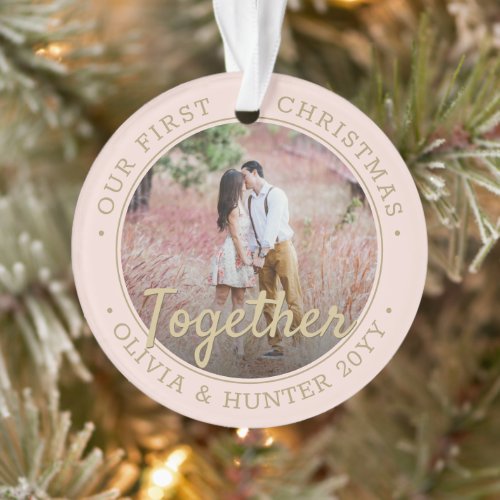 2 Photo First Christmas Together Blush Pink & Gold Ornament - Celebrate the joyful 1st holiday of your relationship or engagement with a custom 2 photo "Our First Christmas Together" blush pink and gold round acrylic ornament. All text and images on this template are simple to personalize and can be different or the same on front and back. (IMAGE & TEXT DESIGN TIPS: 1) To adjust position of wording, add spaces at beginning or end. 2) To center the photo exactly how you want, crop it into a square shape before uploading to the Zazzle website.) As an idea, the script typography can read "Engaged" or "Married." Design features a stylish blush pink border, gold handwritten style calligraphy, the couple's names & year, and two pictures of your choice. Please note that gold is printed color, not metallic foil. This unique romantic keepsake adds an elegant touch to Xmas home decorations or makes a thoughtful wedding gift idea.