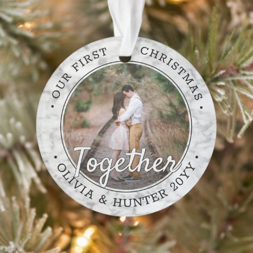 2 Photo First Christmas Together Faux Marble Round Ornament - Celebrate the joyful 1st holiday of your relationship or engagement with a custom 2 photo "Our First Christmas Together" round faux marble acrylic ornament. All text and images on this template are simple to personalize and can be different or the same on front and back. (IMAGE & TEXT DESIGN TIPS: 1) To adjust position of wording, add spaces at beginning or end. 2) To center the photo exactly how you want, crop it into a square shape before uploading to the Zazzle website.) As an idea, the script typography can read "Engaged" or "Married." Design features a stylish black and white faux marble border, handwritten style calligraphy, the couple's names & year, and two pictures of your choice. This unique romantic keepsake adds an elegant touch to Xmas home decorations or makes a thoughtful wedding gift idea.
