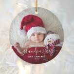 2 Photo Grandparents First Christmas White Script Ceramic Ornament<br><div class="desc">Help them celebrate their first grandchild with this beautiful modern keepsake ornament. The white text reads "Our first Christmas as grandparents, " with the word "grandparents" in elegant handwriting script with flourishes before and after. Easily replace the two sample images with your favorite photos of the new baby, and add...</div>