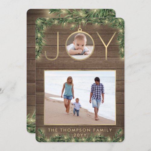 2 Photo Joy Ornament Vintage Wood & Garland Lights Holiday Card - Celebrate the simple joys of the holidays and share two of your favorite photos with an elegant custom Christmas card. Text on this template is easy to personalize with any wording, such as Merry Christmas, Happy Holidays, Seasons Greetings, Cheers to the New Year etc. (IMAGE PLACEMENT TIP: One way to center a photo exactly how you want is to crop it before uploading to the Zazzle website.) The modern farmhouse style design features a rustic brown faux wood background, festive watercolor pine greenery with string lights, faux gold foil JOY ornament, modern minimalist typography, and 2 pictures of your choice. Please note that gold is printed color, not foil. Family and friends will love displaying this stylish customized card.