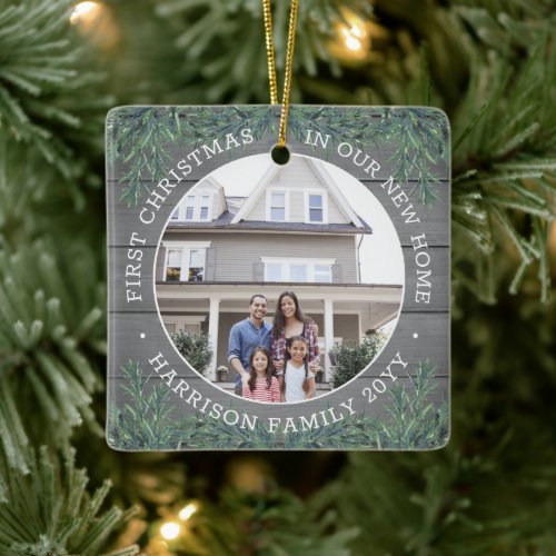 2 Photo New Home 1st Xmas Faux Gray Wood & Pine Ceramic Ornament - Celebrate the joy of your new place with a custom two photo "First Christmas in our New Home" square ceramic ornament. Text and pictures on this template are simple to personalize for any occasion. (IMAGE & TEXT DESIGN TIPS: 1) To adjust position of wording, add spaces at beginning or end. 2) To center the photo exactly how you want, crop it into a square shape before uploading to the Zazzle website.) Modern farmhouse style design features a rustic grey faux wood background, festive watercolor pine greenery, stylish typography name and year, and 2 images of your choice. This unique family keepsake adds an elegant touch to Xmas home decorations or makes a thoughtful housewarming realtor gift idea. There's no place like a new home for the holidays!