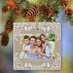 2 Photos Family Winter Greenery Tan Christmas Ceramic Ornament<br><div class="desc">This light tan Christmas ornament showcases an elegant white winter greenery illustration that frames the horizontal photo. The design offers space for 2 of your favorite pictures,  one on the front and another on the back. Personalize this lovely keepsake ornament with your family name and the year.</div>