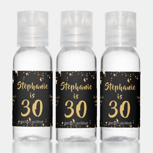 30th Birthday Modern Black Gold Stars Party Favor Hand Sanitizer - Celebrate a 30 year old (or any age as the text is editable) and thank party guests with these personalized party favor gifts designed in an editable black background color and gold text color with gold stars. Include a personal messages on the left and/or right sides. The sample text says THANK YOU FOR CELEBRATING WITH US and duplicated on both sides but they can be different. CHANGES:  Change the colors or font style by clicking on CUSTOMIZE FURTHER. Contact the designer via Zazzle Chat or makeitaboutyoustore@gmail.com if you'd like this design modified, on another product or want coordinating items.