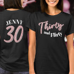 30th birthday thirty flirty pink silver glitter T-Shirt<br><div class="desc">Thirty and flirty, 30th birthday glitter style effect thirty script text in rose pink and silver hues with with text on dark colored t-shirt and a number 30 ans your name on the reverse. Personalize this 30th birthday shirt with your message. Other years and matching items are available. © Original...</div>
