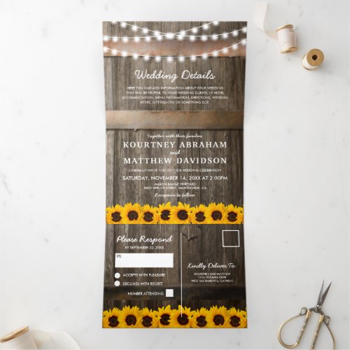 3 in 1 Rustic Country Sunflower Wedding Tri-Fold Invitation - A 3 in 1 rustic country wedding trifold invitation featuring a rustic wooden barrel background, twinkle string lights, bright yellow sunflowers, your monogram, wedding details, wedding invite, and an rsvp postcard for your guests to cut off and send back.