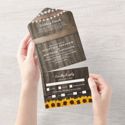3 in 1 Rustic Sunflower Wedding All In One Invitation - A 3 in 1 rustic country chic wedding trifold invitation featuring a rustic wood barrel background, twinkle string lights, bright yellow sunflowers, your monogram, wedding details, wedding invite, and a meal rsvp postcard for your guests to tear off and send back.