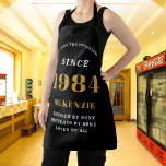 40th Birthday 1984 Name Chic Elegant Black Gold Apron<br><div class="desc">Elegant Black & Gold Chic Apron - 40th Birthday 1984 Name Personalized Kitchen & BBQ Essentials. Celebrate a fabulous birthday with style and practicality! This Elegant Black & Gold Chic Apron, personalized for those born in 1984, is the perfect accessory for the culinary enthusiast in your life. Its eye-catching design,...</div>