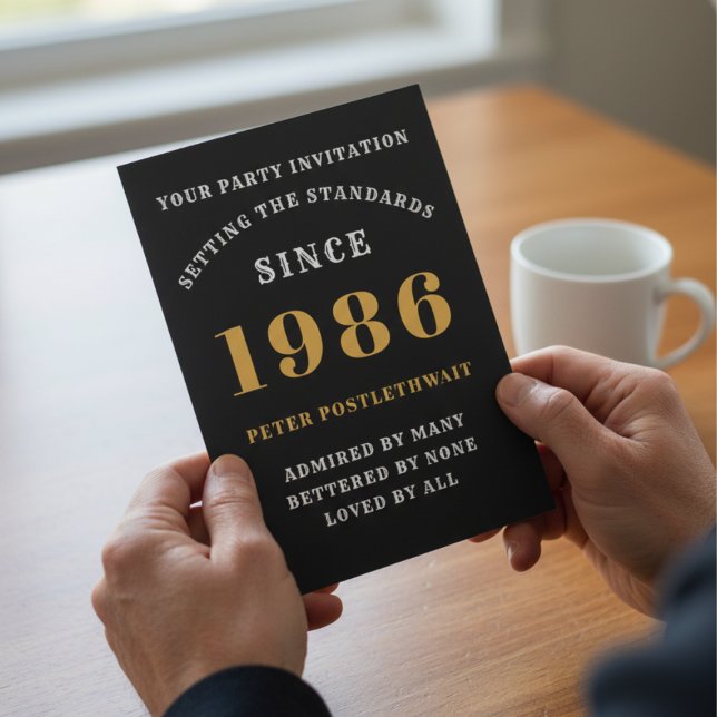 40th Birthday 1986 Black Gold Personalized For Him Invitation (1986 40th birthday invitation held in hands over a table.)