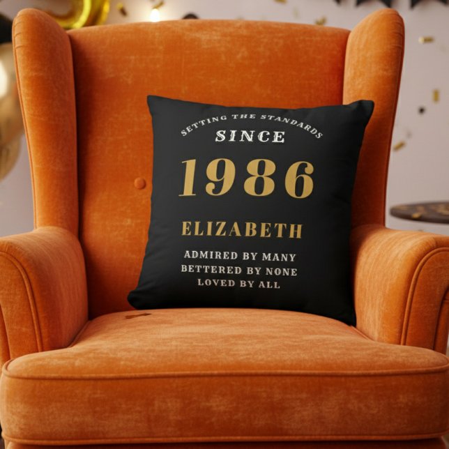 40th Birthday Gift Personalized 1986 Black Gold Throw Pillow (1986 personalized throw pillow on orange chair)