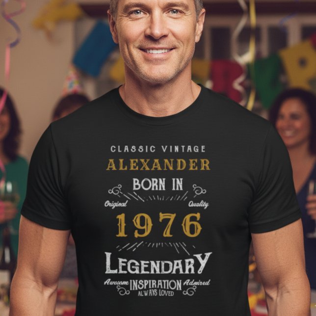 50th Birthday Add Your Name Born 1976 Legendary T-Shirt (Athletic 50 year man wearing a black t-shirt at a party with 1976 printed on it.)