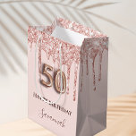 50th birthday blush pink glitter drips rose gold medium gift bag<br><div class="desc">Elegant, classic, glamorous and girly for a 50th birthday party. A blush pink background. Decorated with rose gold, pink faux glitter drips, paint dripping look. Personalize and add a name. With the text: Happy Birthday. The name is written with a modern dark rose colored hand lettered style script. Number 50...</div>