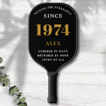 50th Birthday Name 1974 Black Gold Elegant Chic Pickleball Paddle<br><div class="desc">Chic '1974' 50th Birthday Black and Gold Personalized Pickleball Paddle - Elegant Design for Sports Enthusiasts. Celebrate a significant milestone in style with our chic '1974' 50th birthday black and gold pickleball paddle. Elegantly designed and fully personalized, this paddle blends birthday charm and utility in one. Ideal for anyone with...</div>