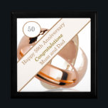 50th Wedding Anniversary Gift Box<br><div class="desc">This lovely Anniversary gift box is perfect for a couples 50th Wedding Anniversary. The suggested theme for this anniversary is gold. With this in mind I have featured two gold wedding rings in the design with a banner and editable text so it can be made truly personal. Perfect to hold...</div>