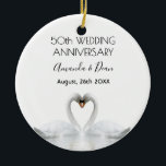50th wedding anniversary white swans in love ceramic ornament<br><div class="desc">Two beautiful swans in love bending their heads toghether and forming a heart. White elegant background,  perfector for a wedding anniversary!  A swan couple stay together for life,  so they are the perfect symbol of love. With the text: 50th Anniversary. Template for two names,  black letters.</div>