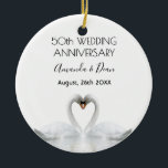 50th wedding anniversary white swans in love ceramic ornament<br><div class="desc">Two beautiful swans in love bending their heads toghether and forming a heart. White elegant background,  perfector for a wedding anniversary!  A swan couple stay together for life,  so they are the perfect symbol of love. With the text: 50th Anniversary. Template for two names,  black letters.</div>