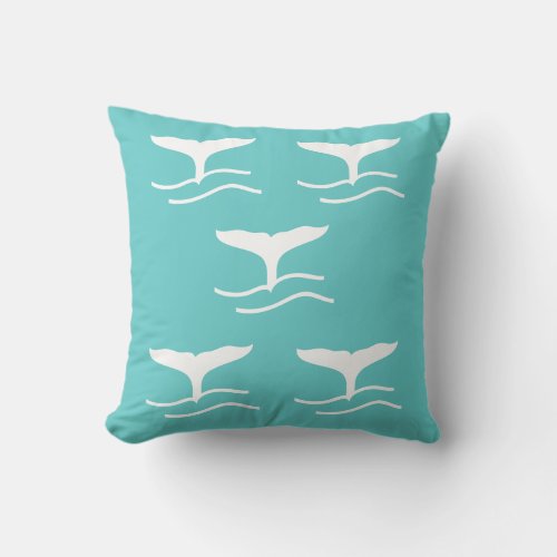 5 white whale tails on teal blue pillow