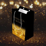 60th birthday black gold bow sparkle medium gift bag<br><div class="desc">Elegant,  classic,  glamorous and feminine style party gift bag for a 60 year old woman.  A gold colored ribbon and bow with faux golden glitter and sparkle,  a bit of bling and luxury for a birthday.  Black background. Golden text: Happy 60th Birthday!</div>