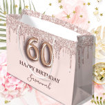 60th birthday blush pink glitter drips rose gold large gift bag<br><div class="desc">Elegant, classic, glamorous and girly for a 60th birthday party. A chic blush pink background. Decorated with rose gold, pink faux glitter drips, paint dripping look. Personalize and add a name. With the text: Happy Birthday. The name is written with a modern dark rose colored hand lettered style script. Number...</div>