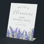 60th Birthday Party Blue July Birth Flower Welcome Pedestal Sign<br><div class="desc">Elegant summer watercolor blue larkspur flowers create a beautiful floral border at the bottom of this birthday party welcome sign,  larkspur or delphinium flowers are the July birth flower. A trendy font combination gives it a modern aesthetic. All of the text is editable.</div>
