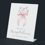 60th Birthday Party Pink Bow Wildflower Welcome Pedestal Sign<br><div class="desc">A pretty blush pink coquette bow is accented by small,  dainty blue and pink wildflowers. Three lines of text below let you personalize the sign. All text is editable.</div>