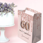 60th birthday rose gold blush glitter drips medium gift bag<br><div class="desc">Elegant, classic, glamorous and girly for a 60th birthday party. A blush pink background. Decorated with rose gold, pink faux glitter drips, paint dripping look. Personalize and add a name. With the text: Happy Birthday. The name is written with a modern dark rose colored hand lettered style script. Number 60...</div>