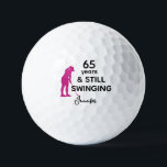 65th Birthday Funny Women Golfer Still Swinging Golf Balls<br><div class="desc">Celebrate her 65th birthday in style with this funny and personalized golf ball designed just for women. Featuring the phrase “65 Years & Still Swinging” with a pink golfer silhouette, it’s a playful way to honor her love for the game. Add her name for a personal touch and create a...</div>