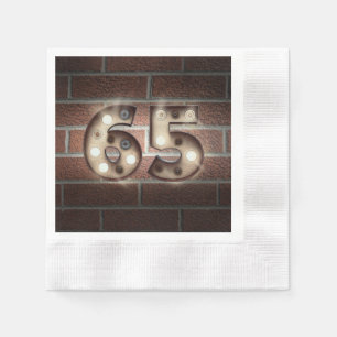 65th birthday marquee sign on brick wall paper napkins