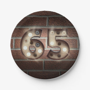 65th birthday marquee sign on brick wall paper plates