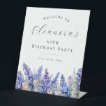 65th Birthday Party Blue July Birth Flower Welcome Pedestal Sign<br><div class="desc">Elegant summer watercolor blue larkspur flowers create a beautiful floral border at the bottom of this birthday party welcome sign,  larkspur or delphinium flowers are the July birth flower. A trendy font combination gives it a modern aesthetic. All of the text is editable.</div>