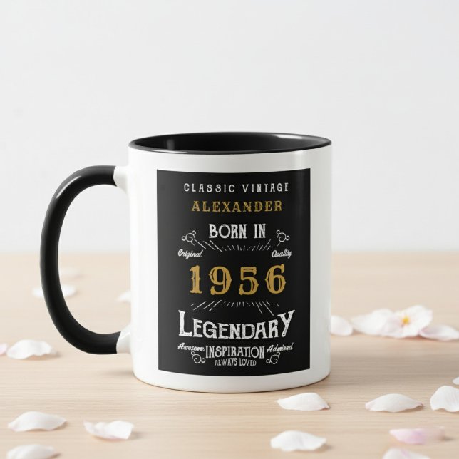 70th Birthday 1956 Legend Retro Black Personalized Mug (Born 1956 birthday gift mug. White wall background, wood table with petals.)