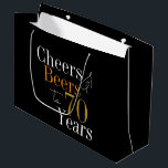 70th Birthday Beers and Cheers Black Gold Party Large Gift Bag<br><div class="desc">This is a cool and modern, 70th birthday party design. It is a simple, minimal design, in classic black and gold typography. Perfect for a cool and fun, 70th birthday party and is ideal as a gift bag or as party favor bags. This design is fully customizable, simply use the...</div>