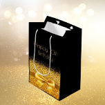 70th birthday black gold bow medium gift bag<br><div class="desc">Elegant,  classic,  glamorous and feminine style party gift bag for a 70 year old woman.  A gold colored ribbon and bow.  Black background. Golden text: Happy 70th Birthday!</div>