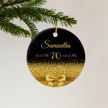 70th birthday black gold elegant bow name ceramic ornament<br><div class="desc">Elegant,  classic,  glamorous and feminine.  A faux gold colored bow with golden glitter and sparkle,  a bit of bling and luxury for a 70th birthday.  Black background. Templates for her name,  age,  date of birth and anniversary date,  both on front and back. Golden letters.</div>