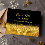 70th birthday party black gold bow save the date postcard<br><div class="desc">Elegant, classic, glamorous and feminine style 70th birthday party save the date postcard. A faux gold colored ribbon and bow with faux golden glitter and sparkle, a bit of bling and luxury for a birthday. Black background. With the text: Save the Date on front written with a modern hand lettered...</div>