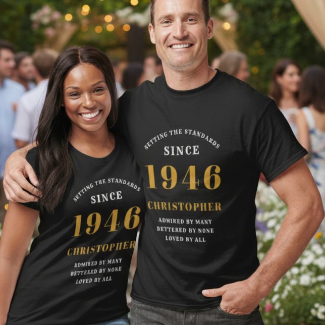 80th Birthday Add Name & Year Black Gold Party T-Shirt (Personalized 1946 t-shirt in black with gold print. Worn by a couple at a garden party.)