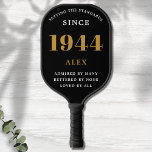 80th Birthday Name 1944 Black Gold Elegant Chic Pickleball Paddle<br><div class="desc">Chic '1944' 80th Birthday Black and Gold Personalized Pickleball Paddle - Elegant Design for Sports Enthusiasts. Celebrate a significant milestone in style with our chic '1944' 80th birthday black and gold pickleball paddle. Elegantly designed and fully personalized, this paddle blends birthday charm and utility in one. Ideal for anyone with...</div>