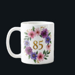 85th Birthday Mug – Floral Wreath with Gold Number<br><div class="desc">Celebrate 85 beautiful years with this elegant floral birthday mug! Featuring a stunning watercolor wreath of pink and violet flowers, lush green leaves, and a golden "85" at the center, this mug makes a perfect gift for any grandmother, mother, aunt, or friend turning 85. Delicate yet vibrant, it’s ideal for...</div>