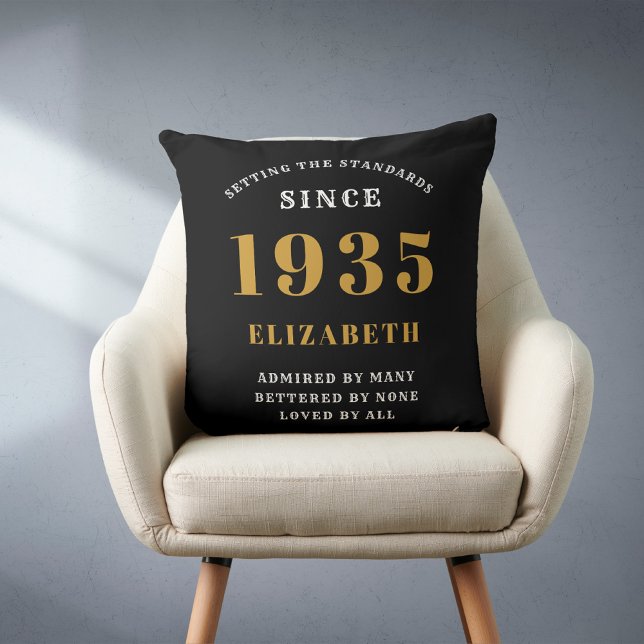90th Birthday 1935 Black Gold lady's Personalized Throw Pillow (Personalized 90 birthday throw pillow on a chair.)