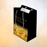 90th birthday black gold bow sparkle medium gift bag<br><div class="desc">Elegant,  classic,  glamorous and feminine style party gift bag for a 90 year old woman.  A gold colored ribbon and bow with faux golden glitter and sparkle,  a bit of bling and luxury for a birthday.  Black background. Golden text: Happy 90th Birthday!</div>