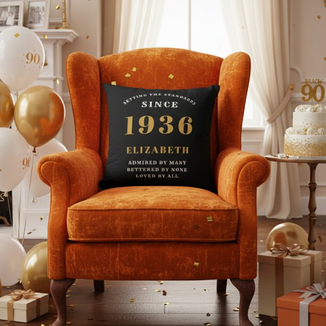 90th Birthday Gift Personalized 1936 Black Gold Throw Pillow (A "Since 1936" pillow on an orange velvet armchair in a 90th birthday decorated room)
