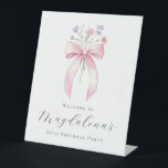 90th Birthday Party Pink Bow Wildflower Welcome Pedestal Sign<br><div class="desc">A pretty blush pink coquette bow is accented by small,  dainty blue and pink wildflowers. Three lines of text below let you personalize the sign. All text is editable.</div>