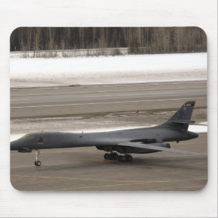 A B-1B Lancer performs a touch and go Mouse Pad