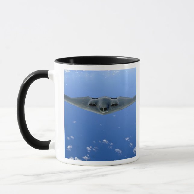 A B-2 Spirit soars through the sky Mug (Left)